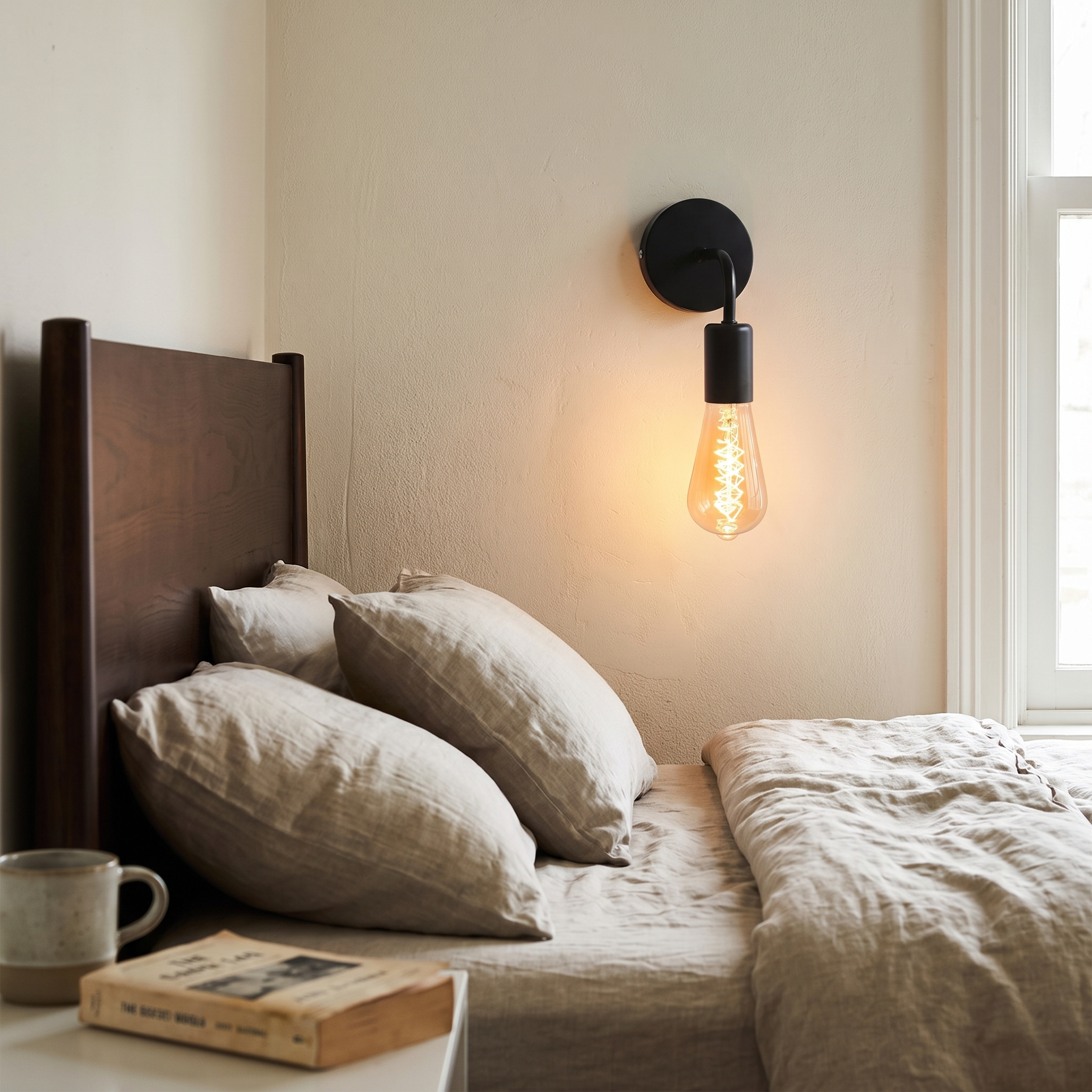 Black iron Nordic wall lamp beside a bedroom headboard