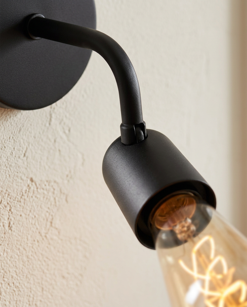 Black Iron Wall Sconce — close detail of the matte black iron arm and pivot joint